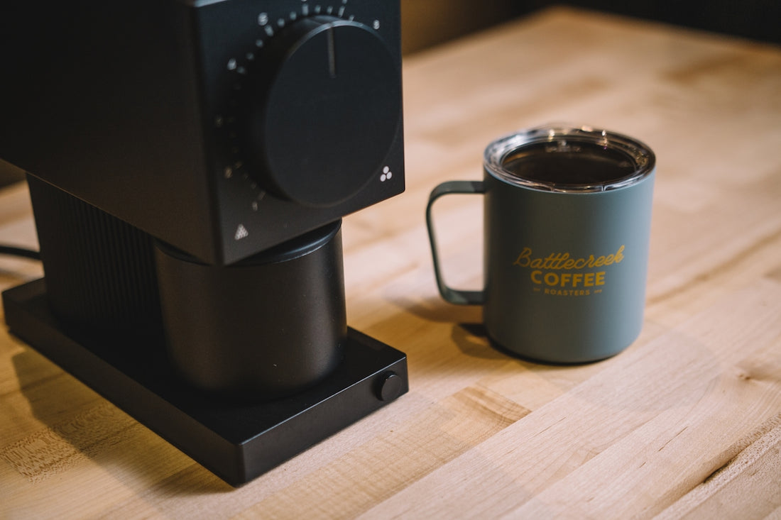black coffee mug on brown wooden table