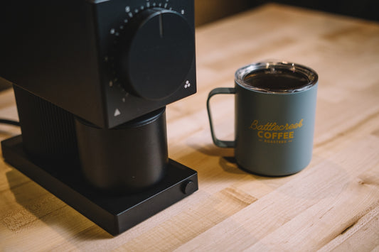 black coffee mug on brown wooden table