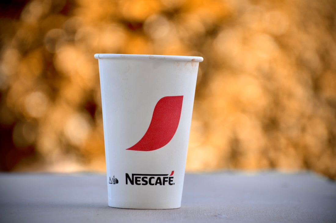 a cup of coffee sitting on top of a table