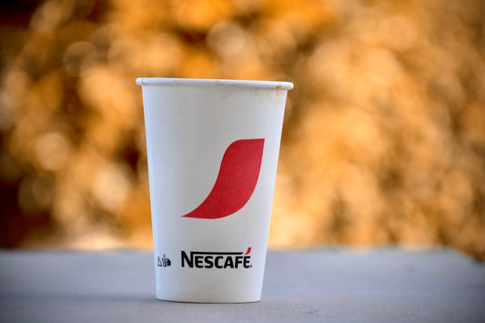 a cup of coffee sitting on top of a table