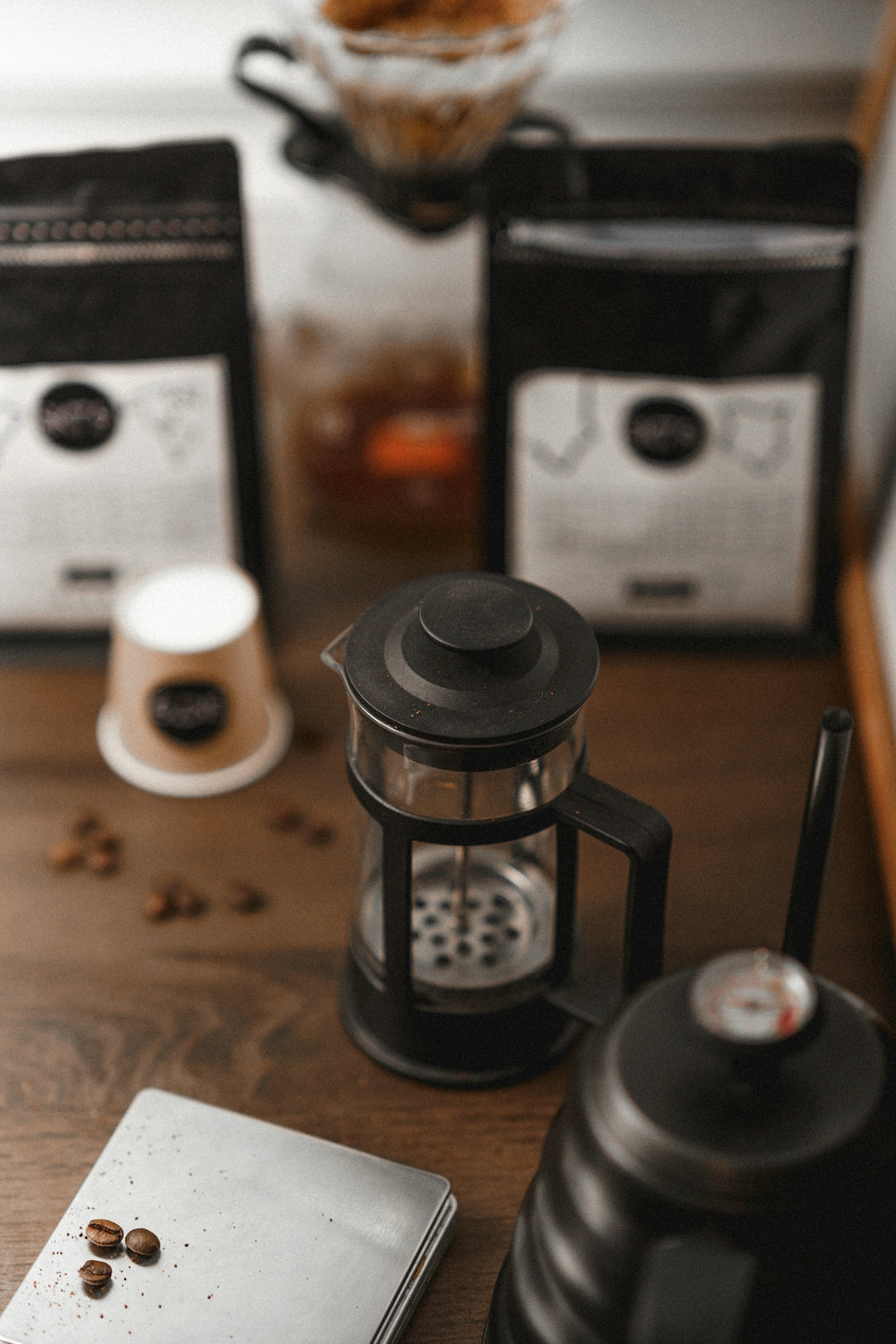 a wooden table topped with two coffee grinders