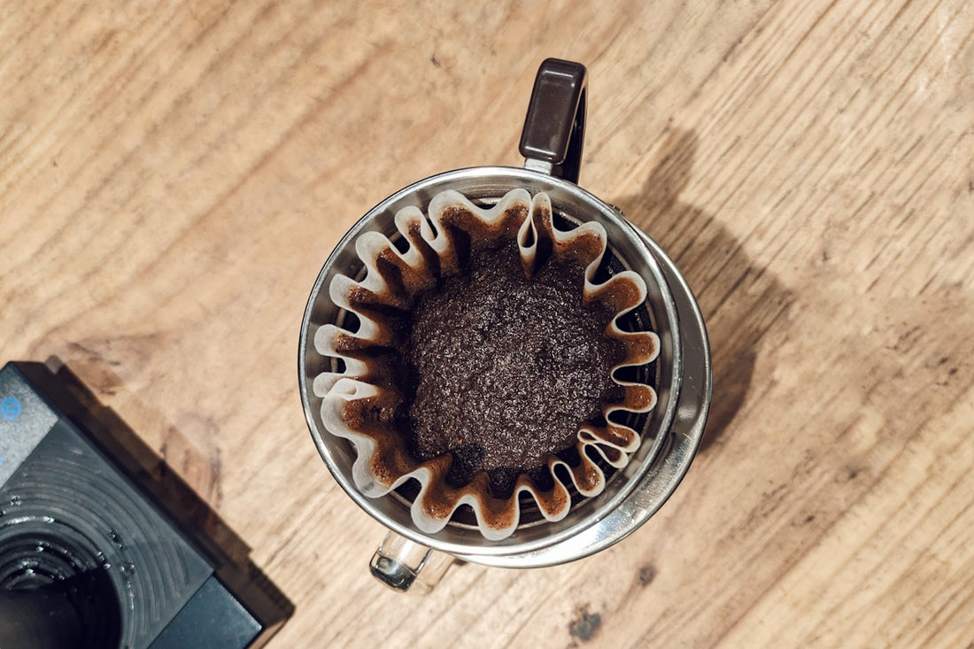 an overhead view of a coffee maker on a wooden table