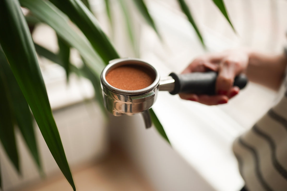 A woman is holding a cup of coffee